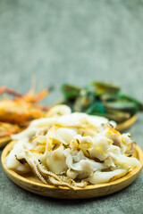 Slice of grilled squid on wood dish