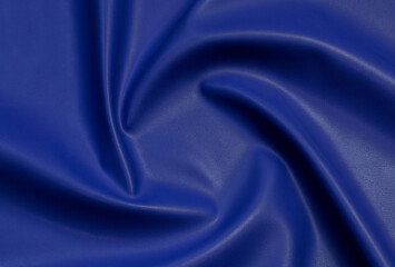 blue artificial leather with waves and folds on PVC base