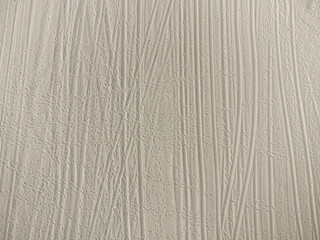 Wheel and footprints in the sand. Top view on sandy beach with trail texture.