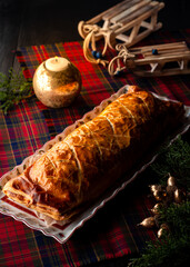 Beef wellington or boeuf en crout cut into slices on christmas background.