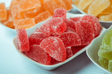 Dessert marmalade in the form of lemon and orange slices. The sweetness of jelly candy.