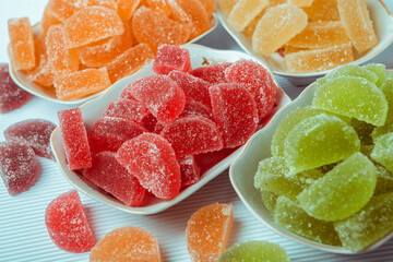 Dessert marmalade in the form of lemon and orange slices. The sweetness of jelly candy.