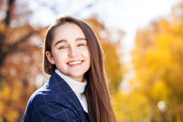  young brunette girl posing in autumn park