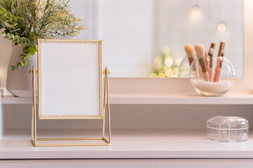 Table mirror on dressing table with make up accessories. Self-Care. White, pastel interior