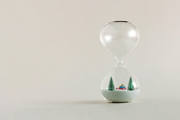 2022. Fir christmas trees and Santa’s sleigh with presents, standing in the hourglass isolated on...