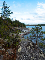 rocks with pine trees on the shore of the lake