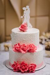 Wedding cake with flowers for a wedding banquet. Delicious reception. Copy space. Celebration party concept. Trendy Cake.