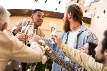 Family and friends celebrating at dinner on a rooftop terrace