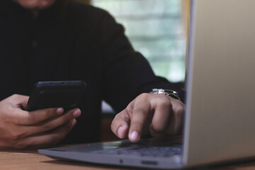 Hands of man using online virtual app on mobile phone. Millennial guy chatting on smartphone, using banking services, reading text message, typing, shopping, making call, browsing internet. Close up