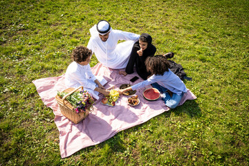 cinematic image of a family from the emirates spending time at the park