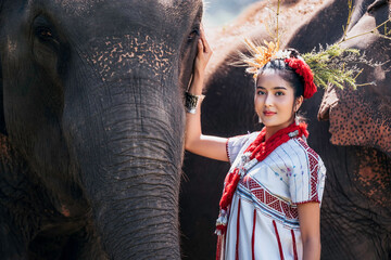 The local Asian woman hugging her best friend elephant with love near forest. The great relationship between friends