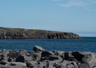 Fototapeta na wymiar Landscape of cliffs rocky coast on sunny day in Keflavik Iceland