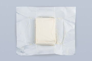 unpacked butter on grey background