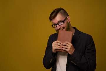 bearded man in a black jacket with a book in his hands education