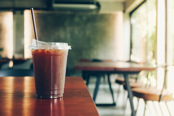 Black ice coffee or Americano coffee on wood table.
