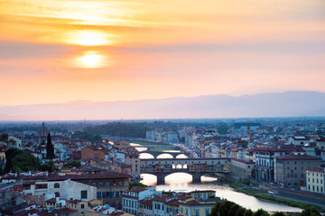 Fototapeta na wymiar Famous bridges over the Arno river in Florence, Italy, at the dawn of the sun. Fantastic romantic landscape.