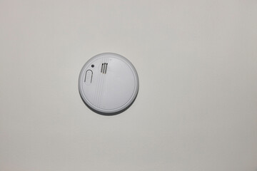 Fototapeta premium View of white home smoke alarm detector isolated. Security system concept. Sweden.