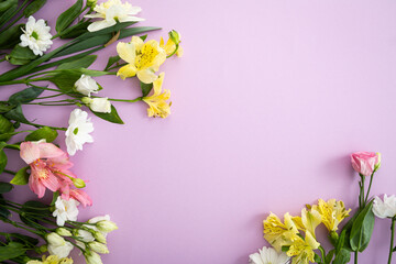Flowers on light pink surface spring concept copy space