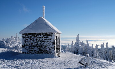 Small stone shelter in winter mountains.