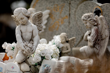 Angel sculptures on gravestone in the cemetery
