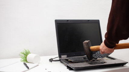 man office worker smashed a laptop, destroyed a computer. Anger, hatred, irritation. Error, brake,...