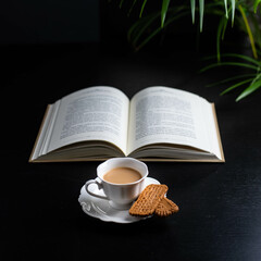 Fototapeta na wymiar Morning reading and a little bone china cup of coffee