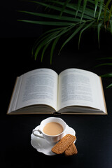 Fototapeta na wymiar Morning reading and a little bone china cup of coffee