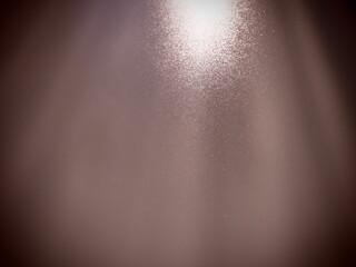rays of light and stripes on a brown or pale burgundy background. Blurred abstract background light...