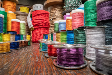 Small tailor workshop with tape measure and threads on spools.