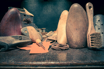 Traditional cobbler workplace with tools, strap, leather and rules.