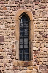 Simple pointed ogive arch of a narrow gothic window at St Peter and Paul church in Echternach, Luxembourg