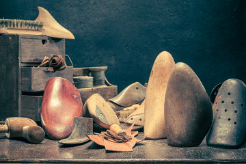 Traditional shoemaker workshop with with tools, anvil, shoes and rule.