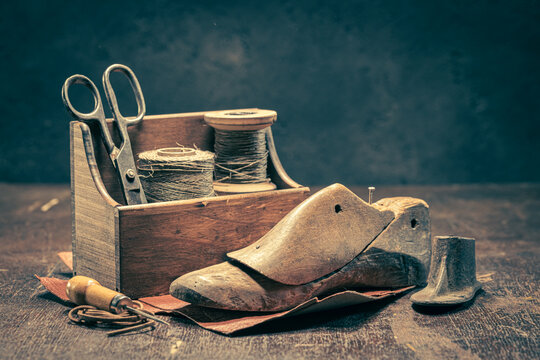 Old shoemaker workshop with tools, rules, leather and strap.