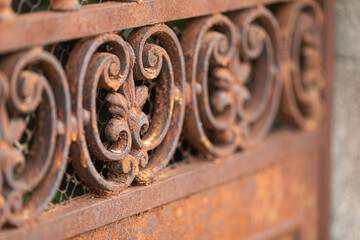 Fototapeta na wymiar Closeup of the ornaments on a rusty metal surface