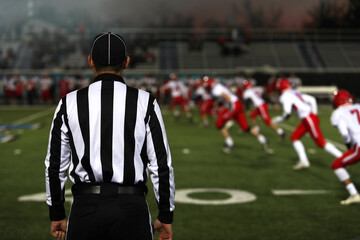 A football official watches the kick-off