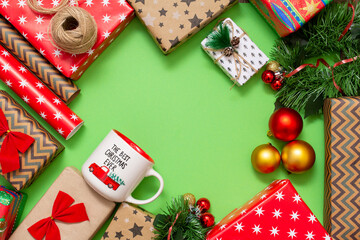 Christmas card with Christmas decorations. Christmas background with gift boxes, ropes, paper handlebars and decorations on red. Preparing for the holidays. Top view with copy space.