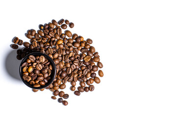 Grains of coffee and a black cup on a white background, top view, place for text, copy space.