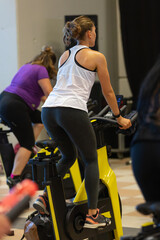 Girl Having Workout at Gym with Indoor Exercise Bike