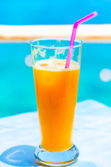 Cocktail glasses at pool, beach side.