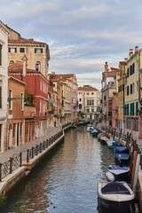 Venice, Italy - 10.12.2021: Traditional canal street with gondolas and boats in Venice, Italy.