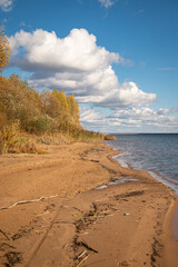 Autumn landscape of the Vileysky reservoir: blue water, sand and sky