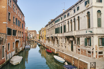 Venice, Italy - 10.12.2021: Traditional canal street with gondolas and boats in Venice, Italy.