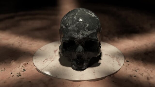 The black marble skull rotates and flips on a white platform in sand. 3d animation of seamless loop