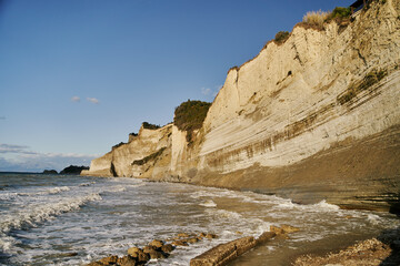 Fototapeta na wymiar View of Logas Beach and the amazing rocky cliff in Peroulades. Corfu island. Greece