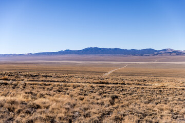 Naklejka na ściany i meble Wide open landscape desert scene with valley and mountains