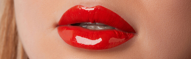 Close up macro female plump lips with red gloss. Beauty fashion portrait personal care and make up