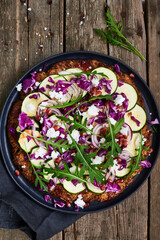 cauliflower pizza with zucchini on the wooden table