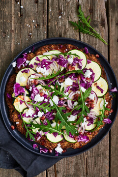 cauliflower pizza with zucchini on the wooden table