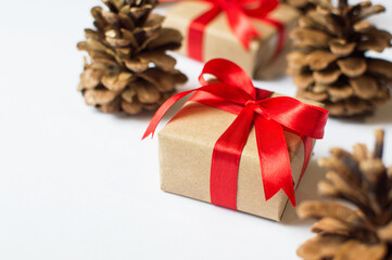 Festive concept - a gift with a bow and bumps on a white background. composition for christmas, new year and holidays. flat lay with place for text.

