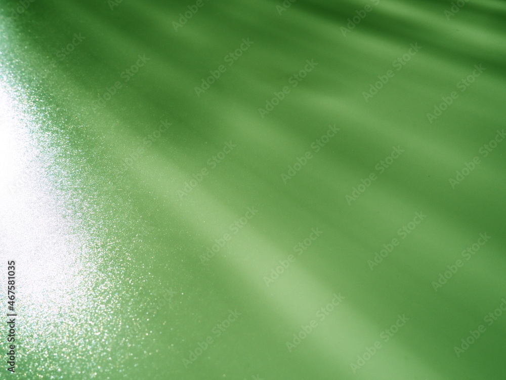 Poster abstract green background. light beams with flickering dots. lines and stripes from top left to bott